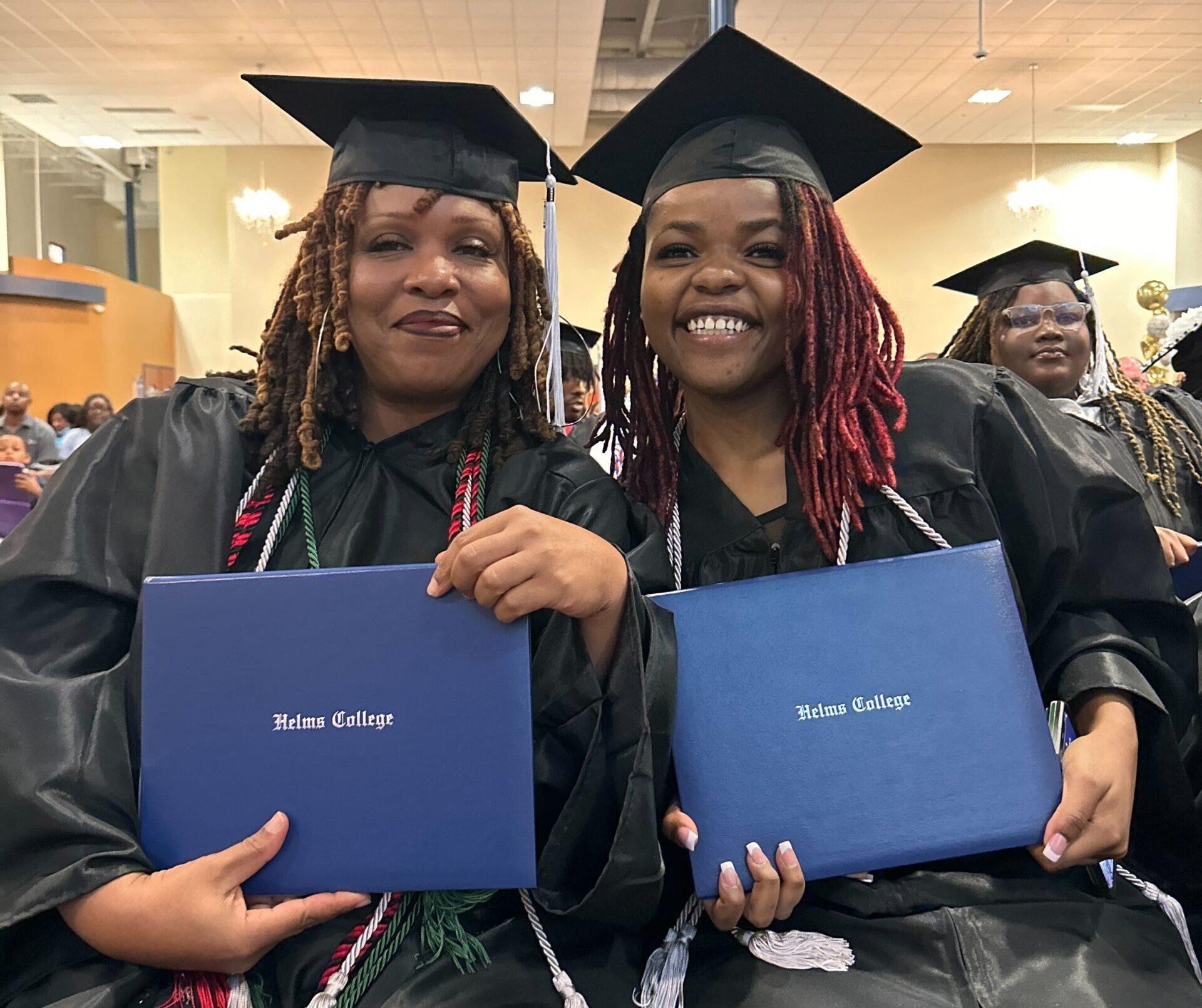 Helms College Macon 2024 Graduates smiling with their diplomas.