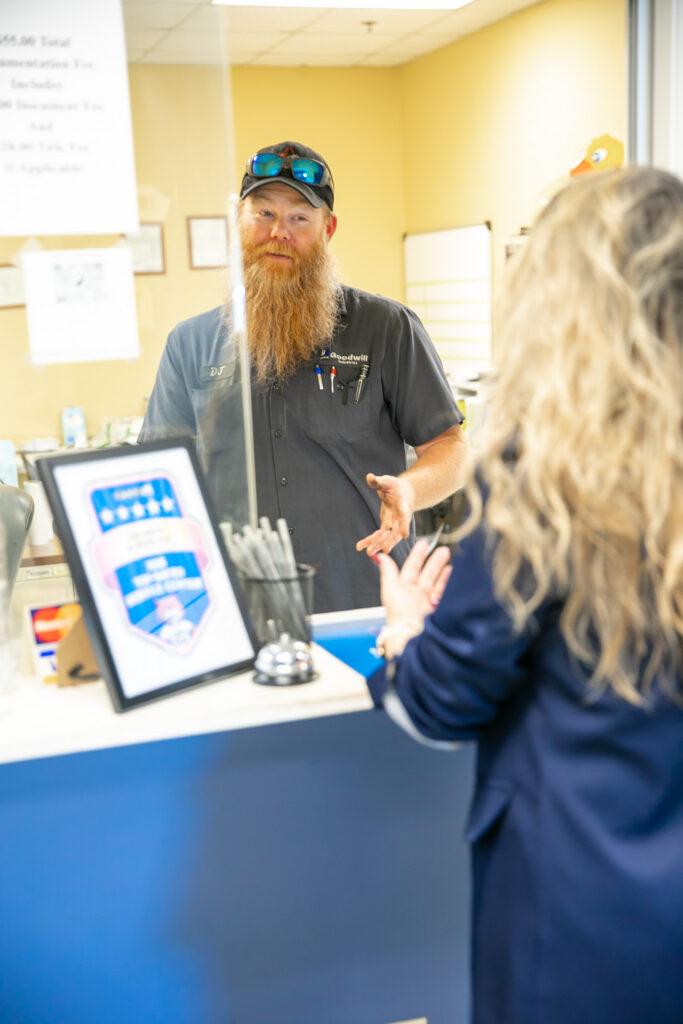 Goodwill Automotive employee talks to customer in Macon, Georgia.