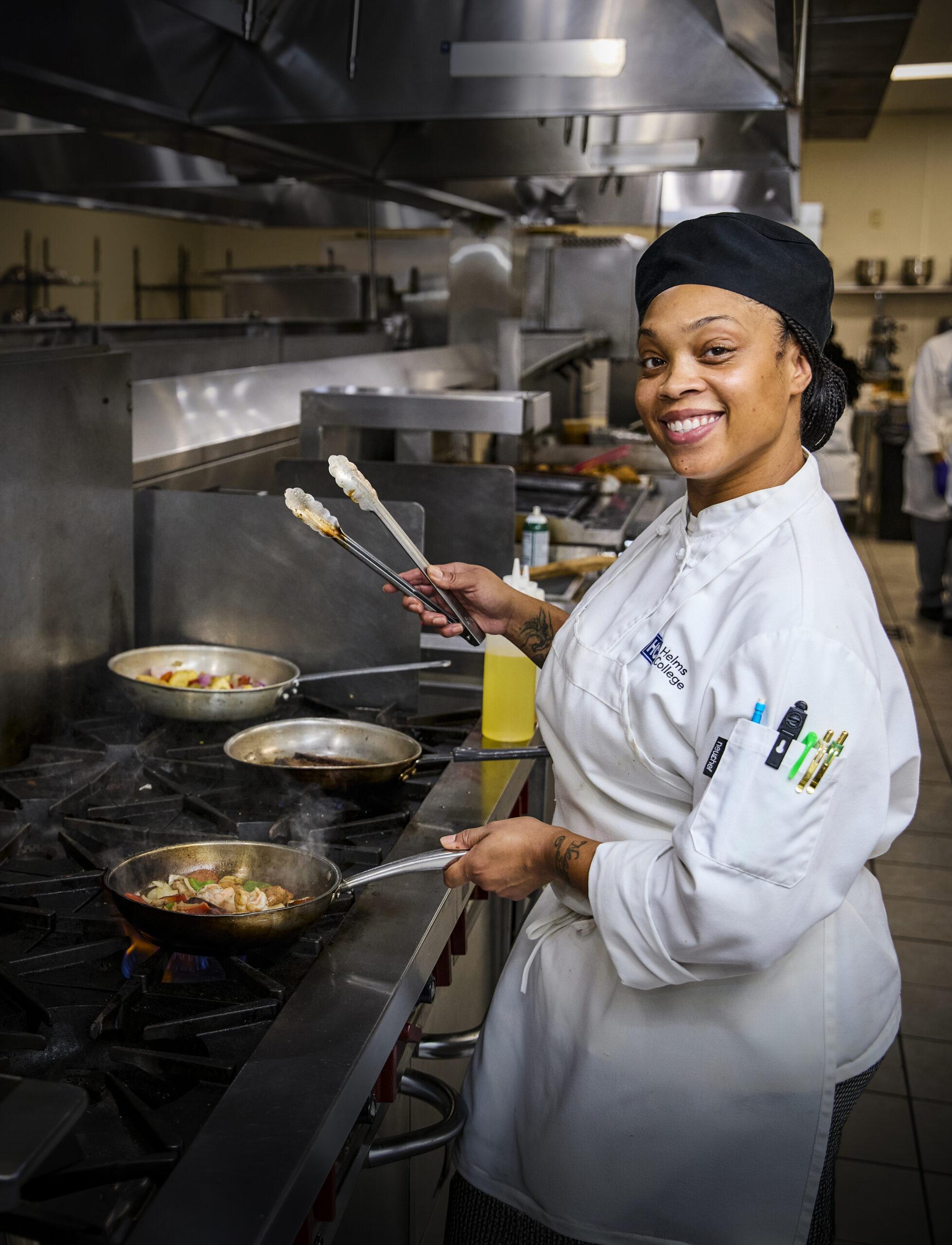 Helms College culinary student works at grill