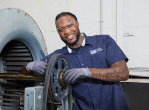 An HVAC student at Helms College